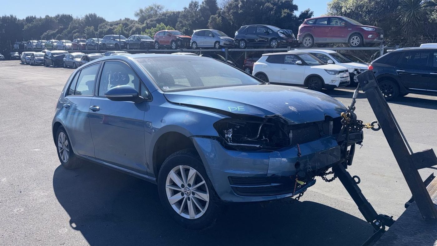 Accident-damaged blue VW Golf with front-end damage in the Queenstown wreckers' yard